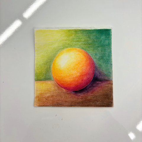 A color pencil artwork on a white table.