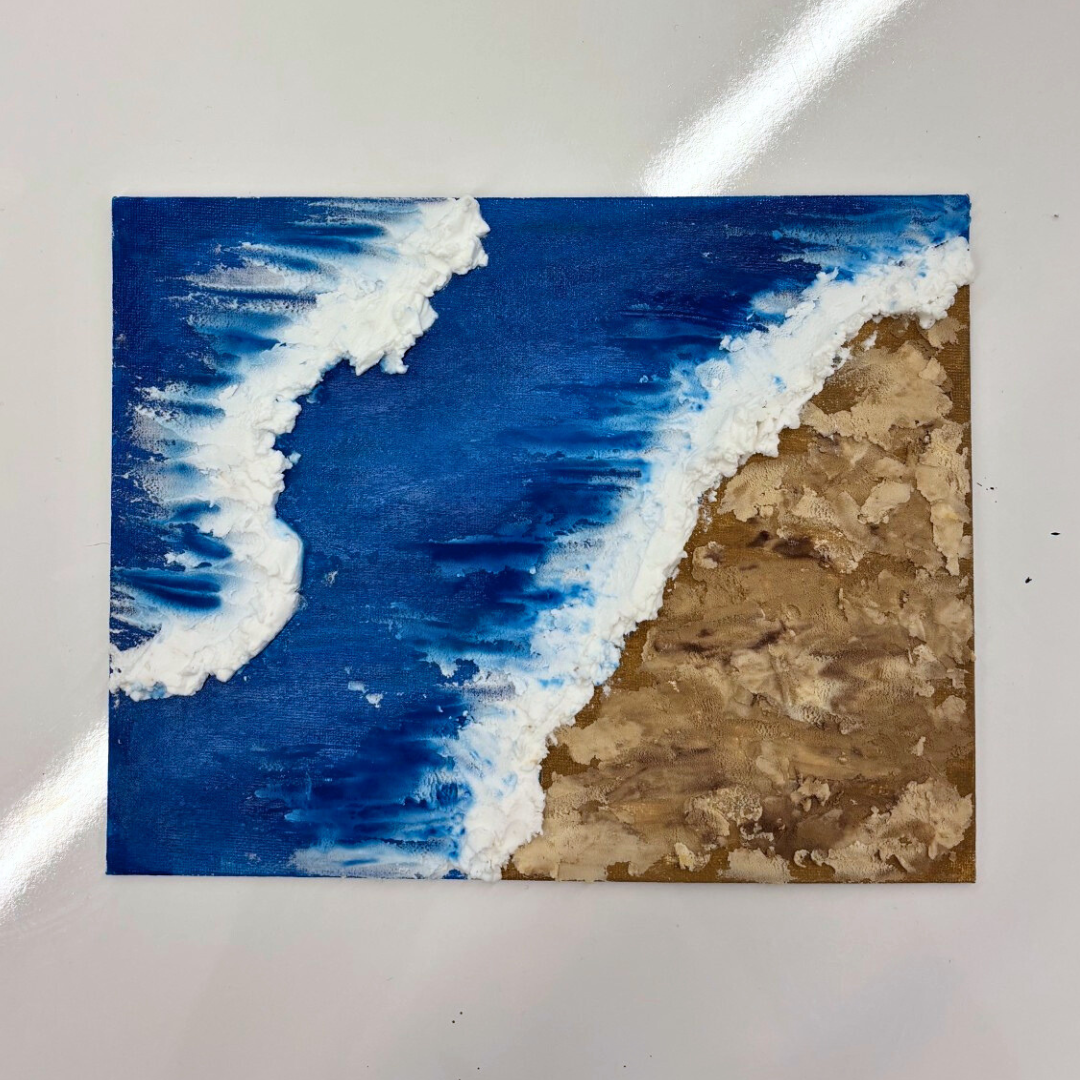 Image depicts artwork that combines paint and modeling paste to show waves crashing on a beach.